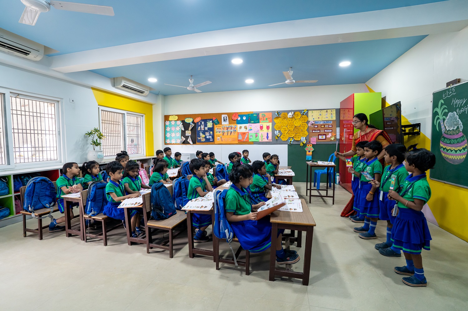 A teacher with young students in a Devi Academy classroom